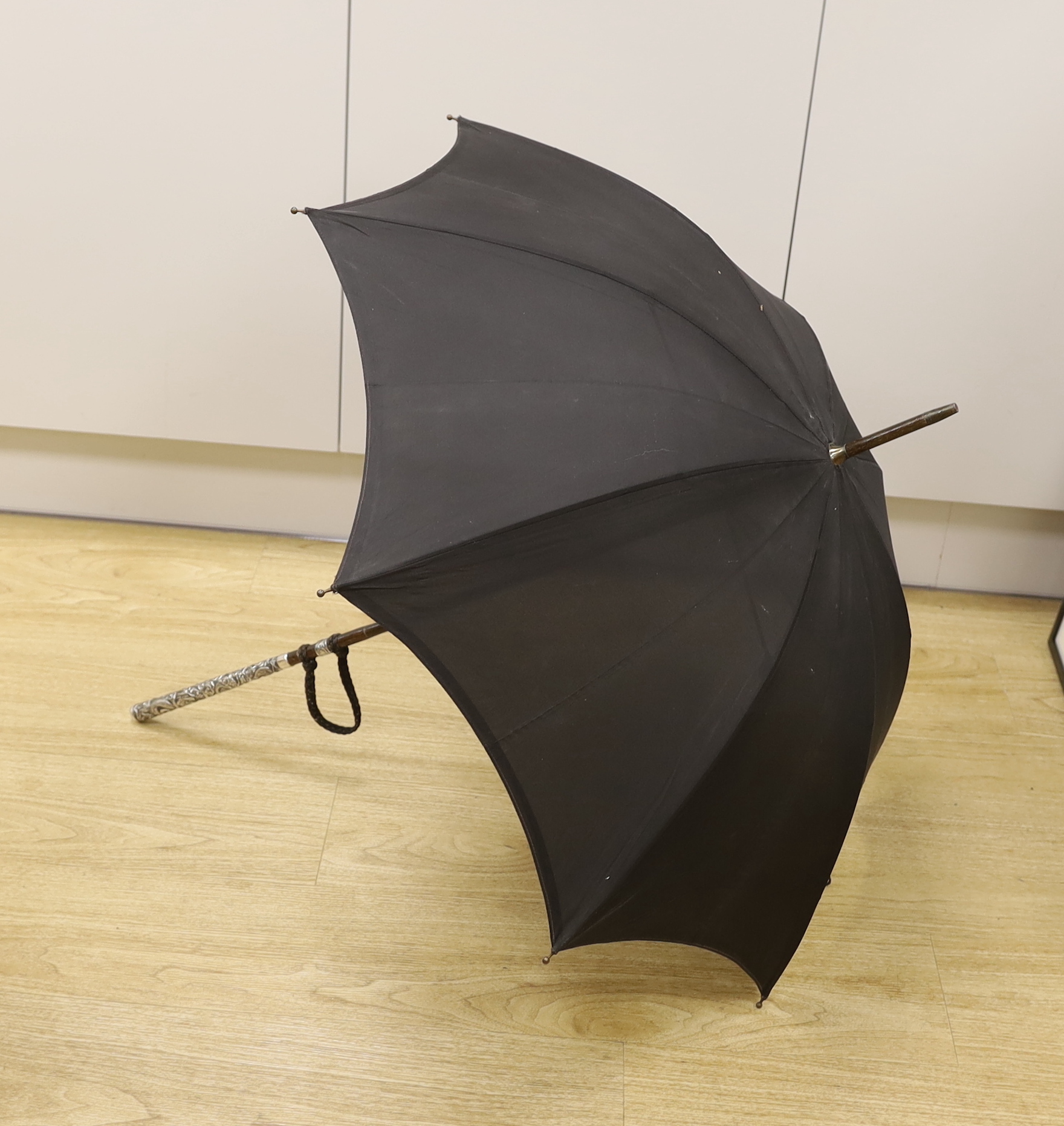 A Chinese white metal handled umbrella with dragon decoration, 94cm long